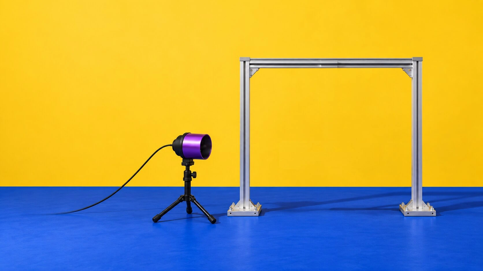 Test rig 07-B against a yellow wall on a blue floor, with a blower on a stand to the left