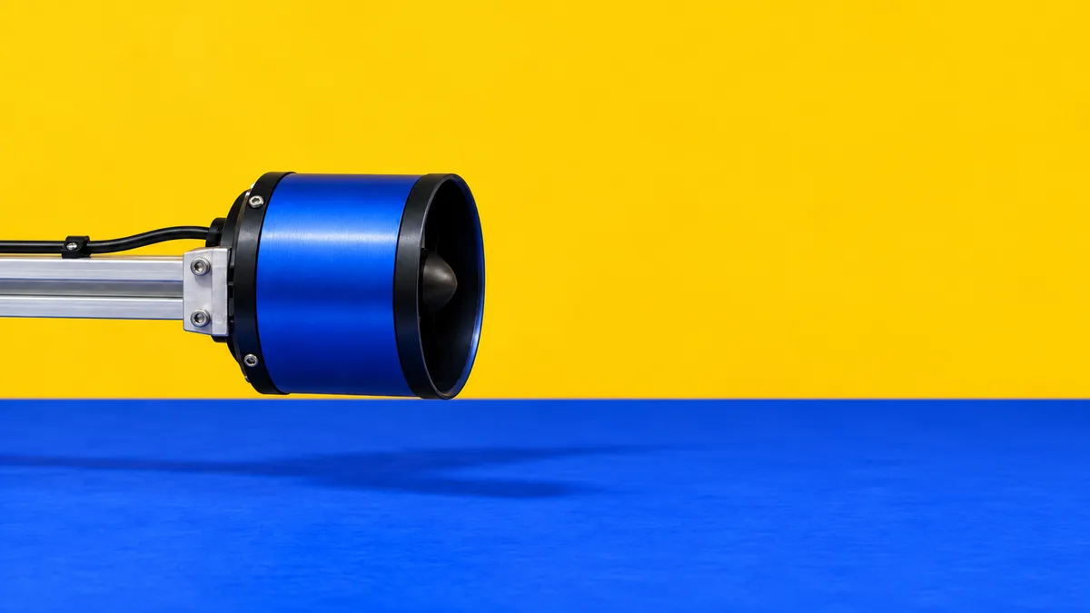 A blue ducted rotor on the test rig.